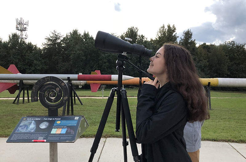 Girl looking through binoculars