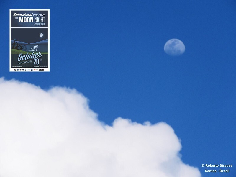 The Moon and a puffy cloud in a blue sky, with an International Observe the Moon Night image stamped in the upper left corner