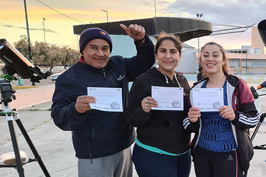 Group of people outdoors holding certificates