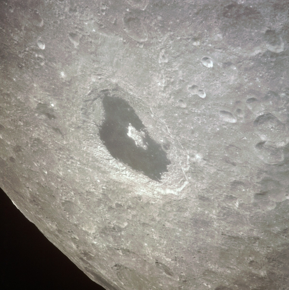 large lunar crater filled with dark, solidified lava