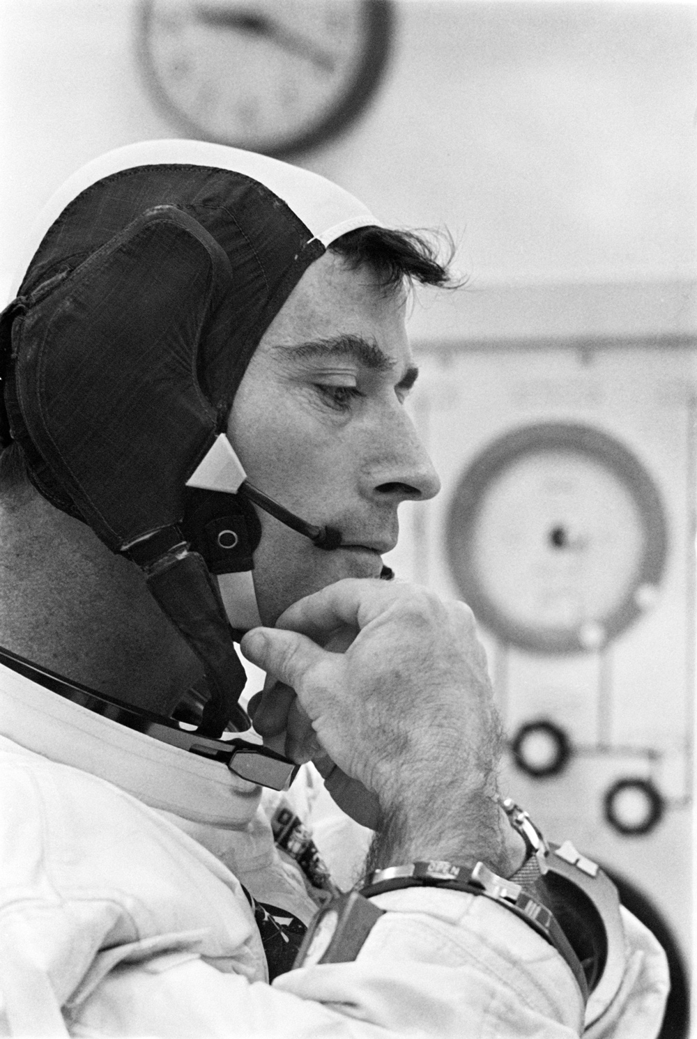 Astronaut adjusting strap on cap