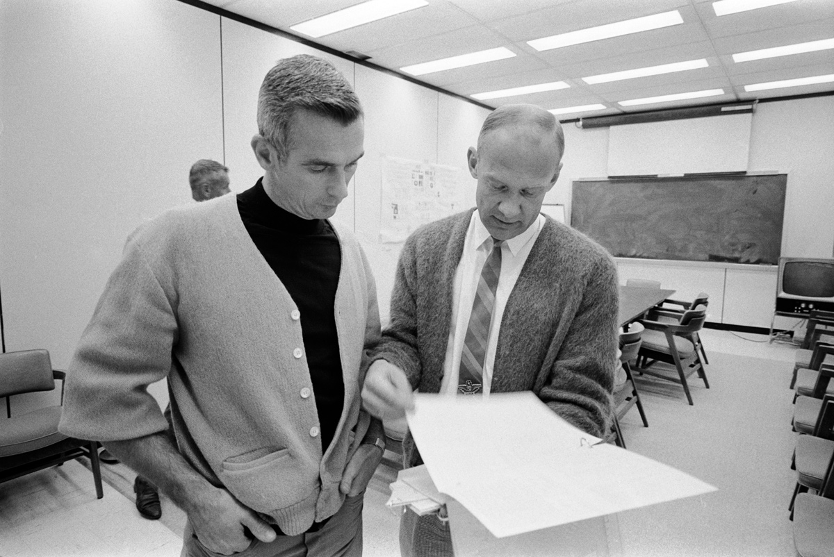 2 men looking at a sheet of paper