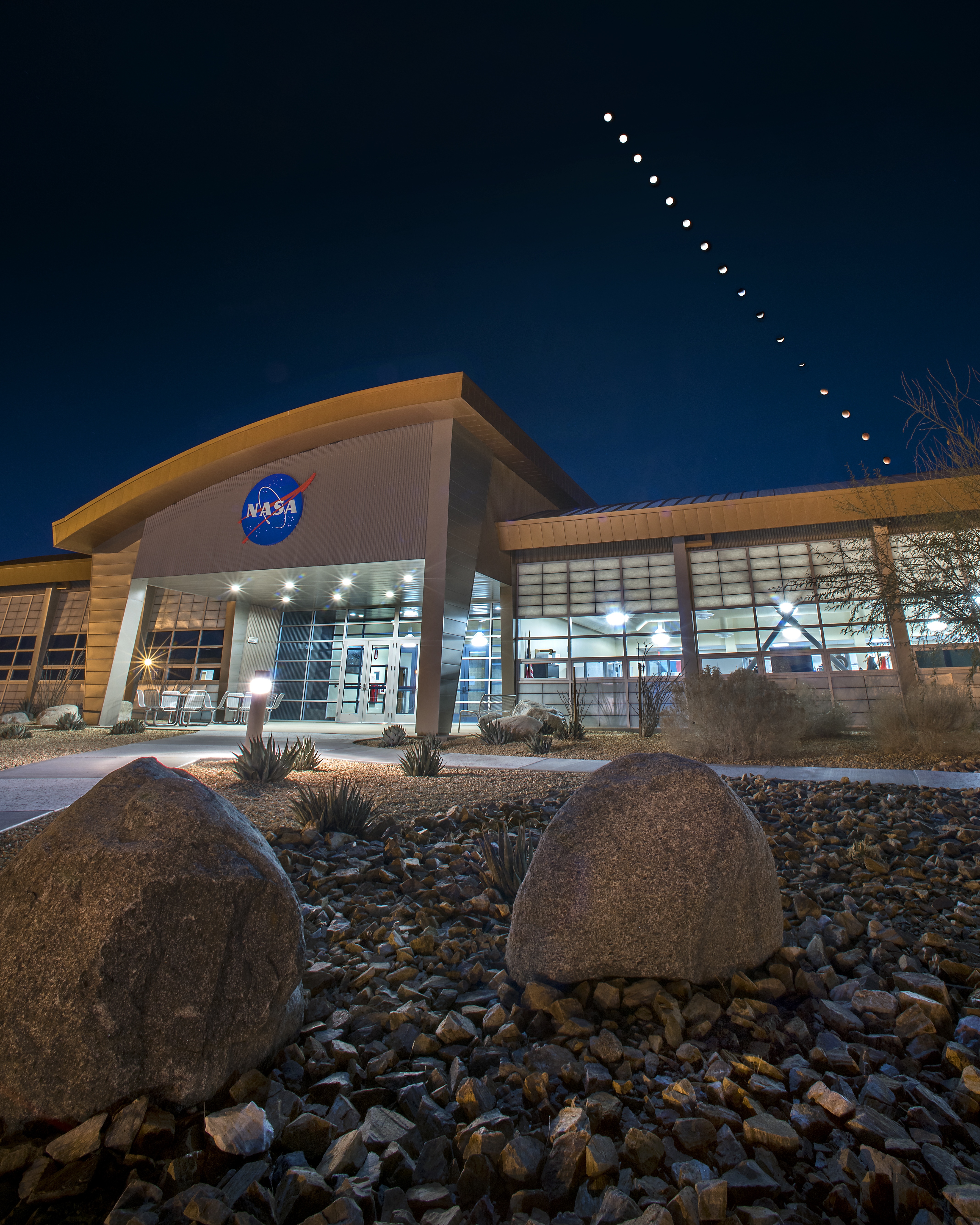 Sequence showing the Moon descending into eclipse above a NASA building.