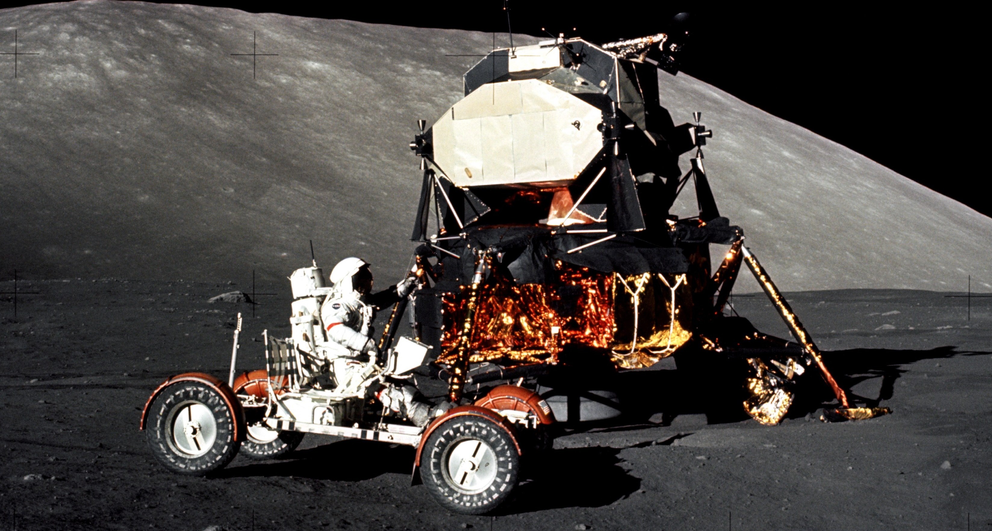 Man in moon buggy on the Moon.