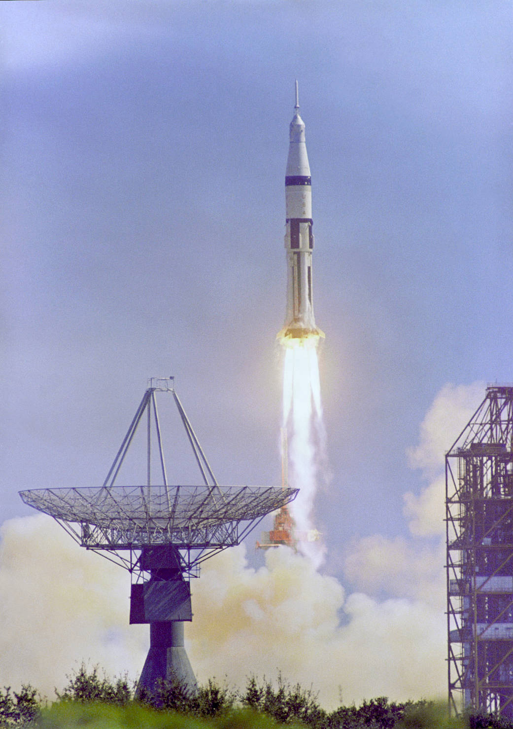 Apollo 7 spacecraft launching with large antenna in foreground
