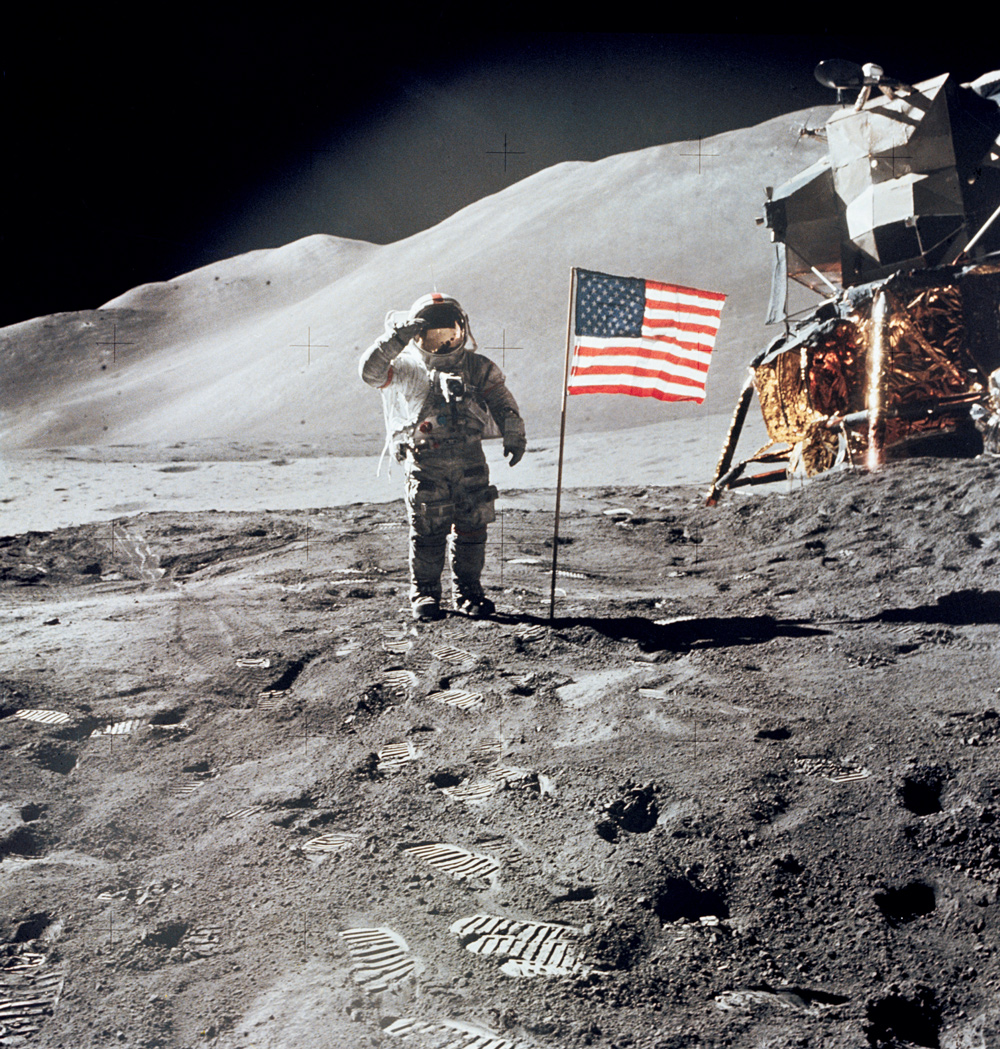 Astronaut giving salute beside American flag on the moon