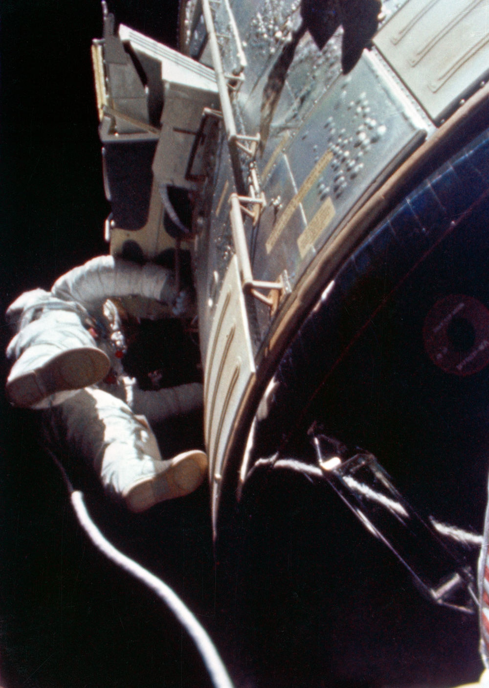 Astronaut floating in space outside spacecraft