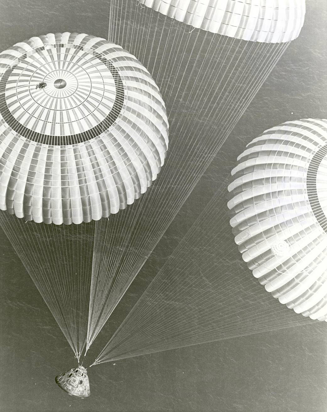 Apollo 17 module and parachutes landing over ocean