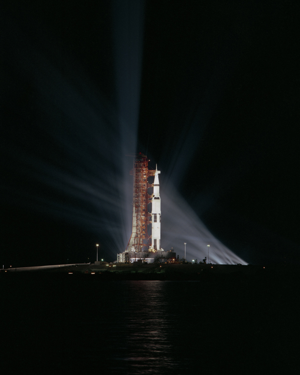 Searchlights illuminate the Apollo 8 spacecraft at night