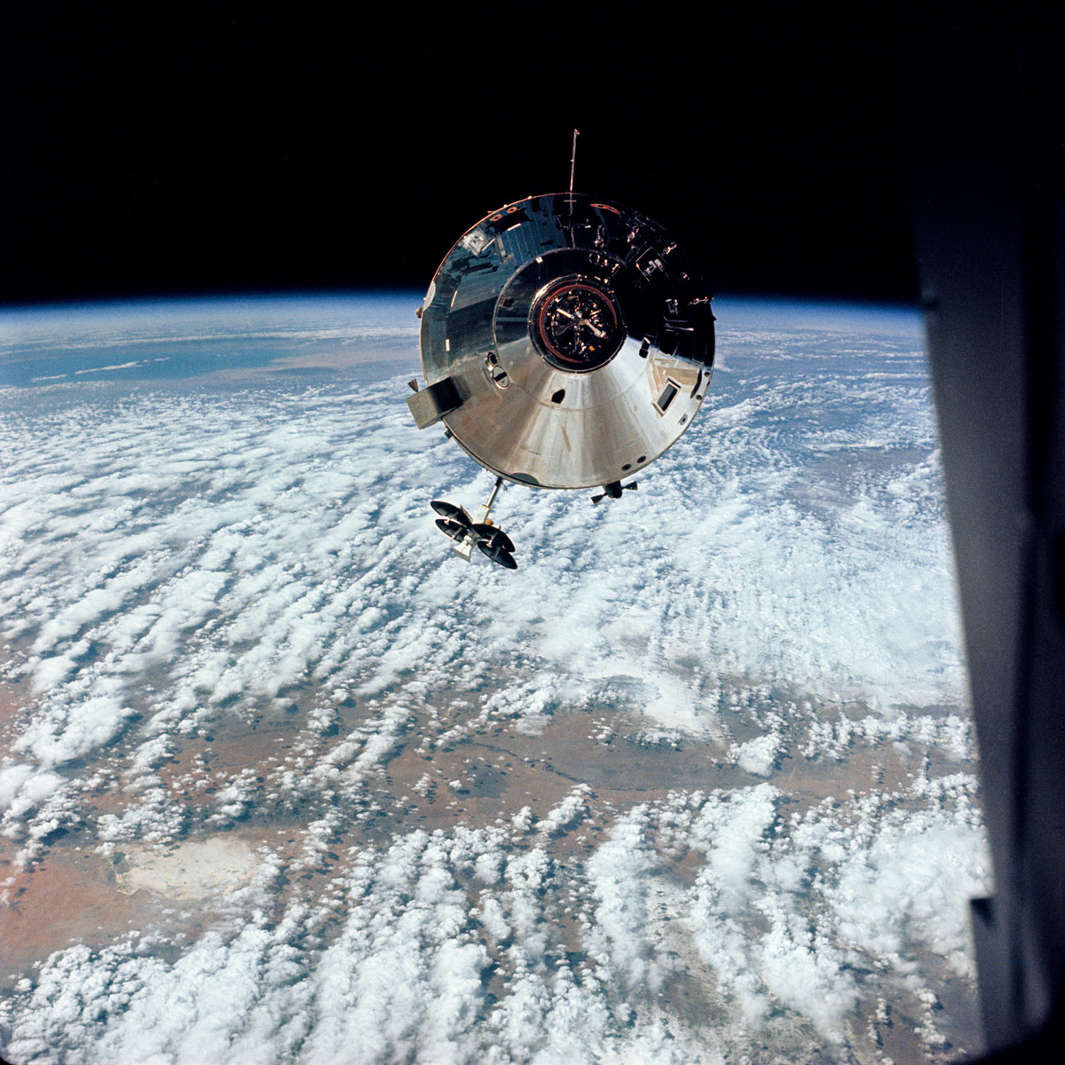 Apollo 9 command module in space with Earth in background