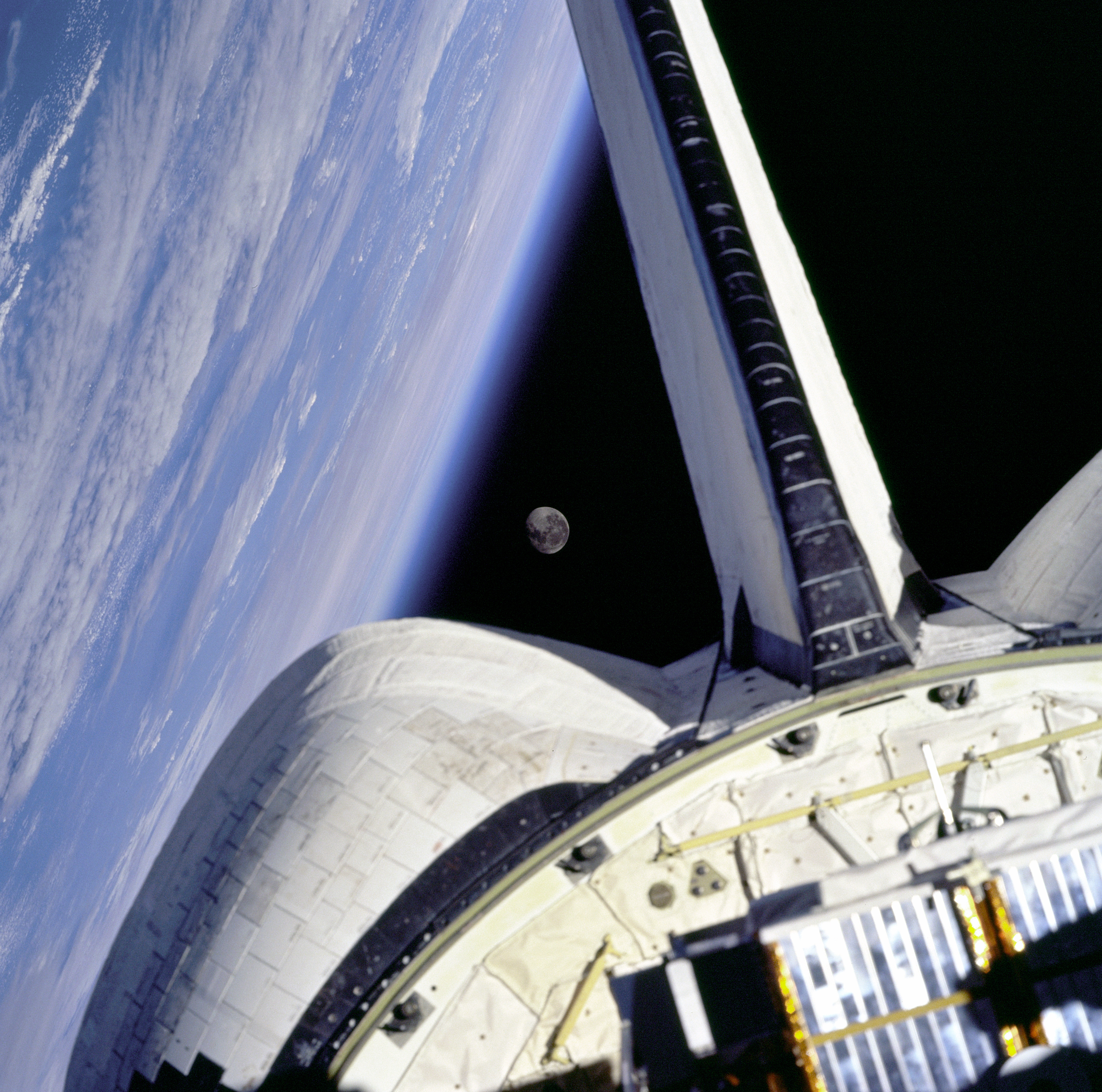 Earth and its Moon are nicely framed in this image taken from the aft windows of the Space Shuttle Discovery in 1998. 