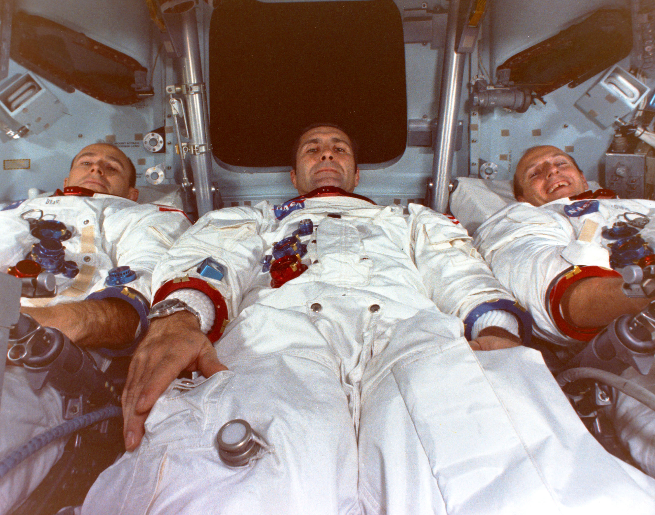 Three men in a space capsule.