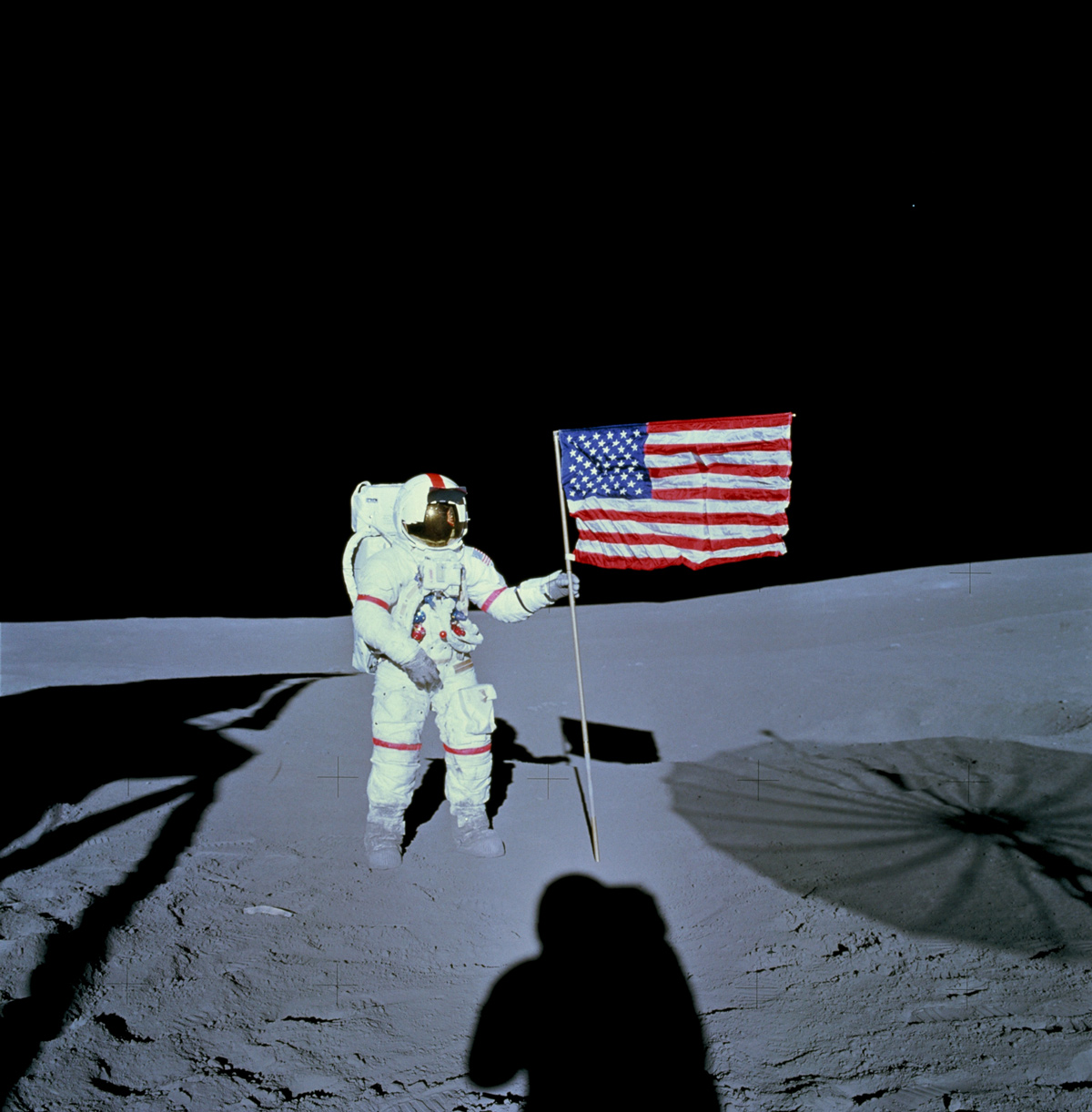 Astronaut holding American flag on the moon