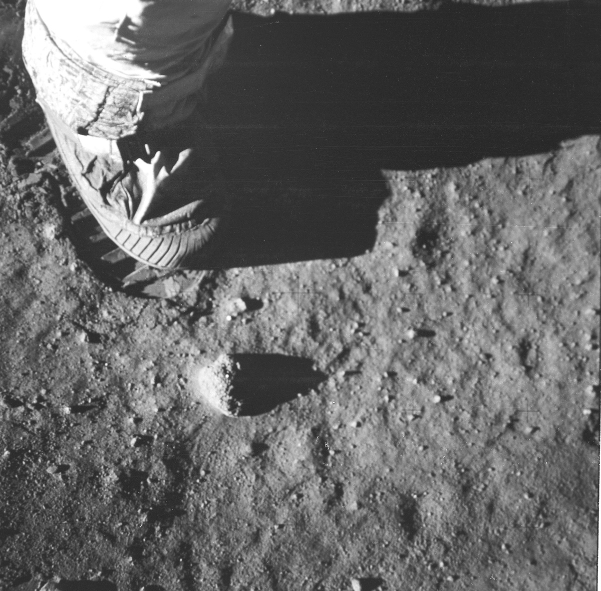 Astronaut's foot and footprint on lunar soil