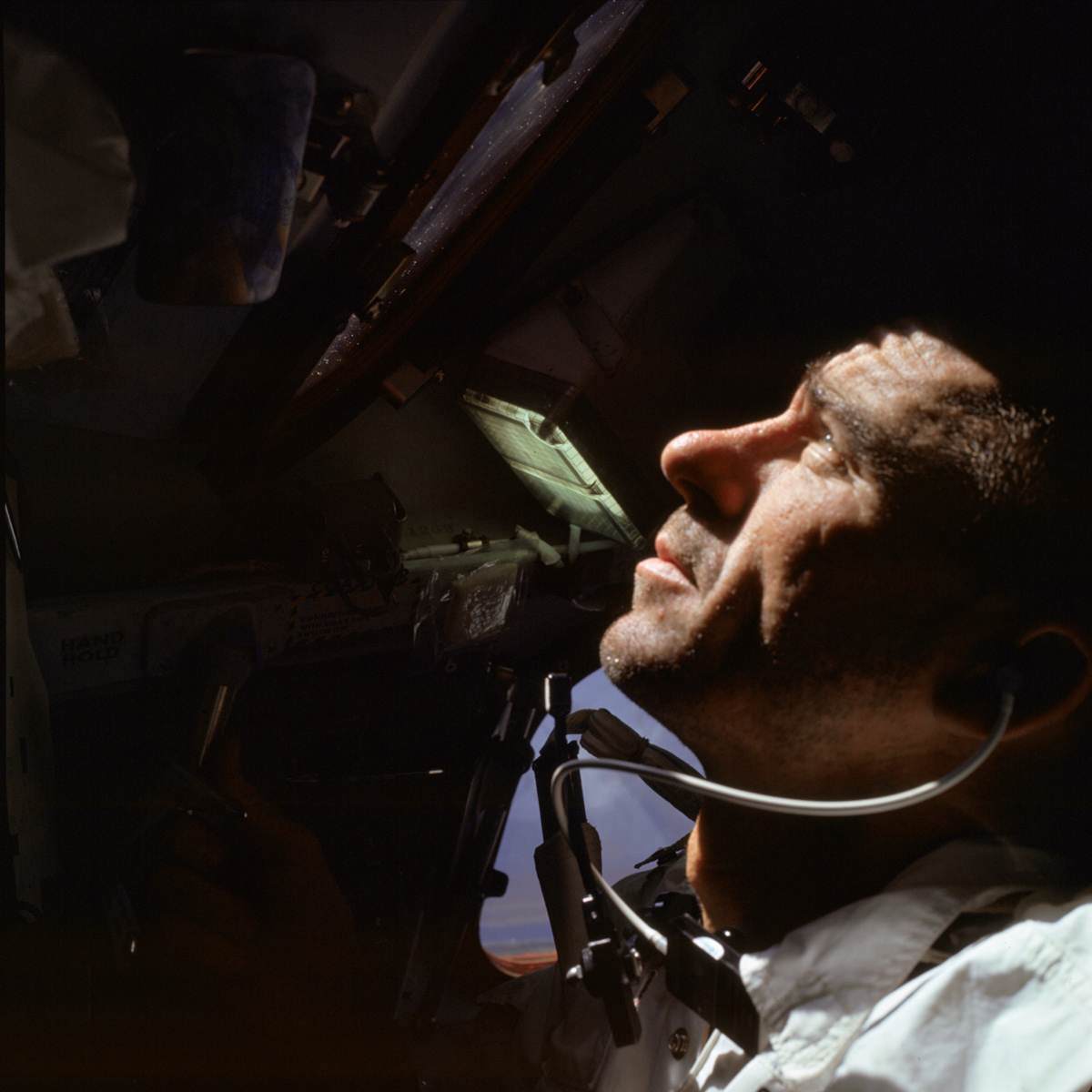Man inside spacecraft, looking up