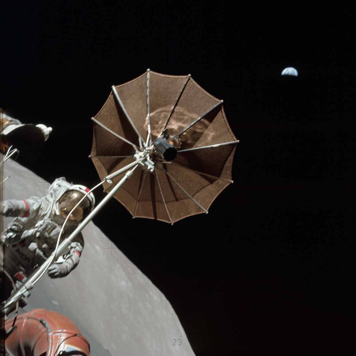 Astronaut on moon holding antenna with Earth in the background