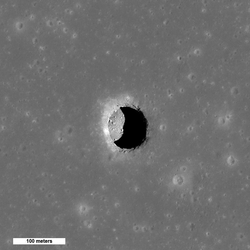 Black and white image of deep crater on the moon.