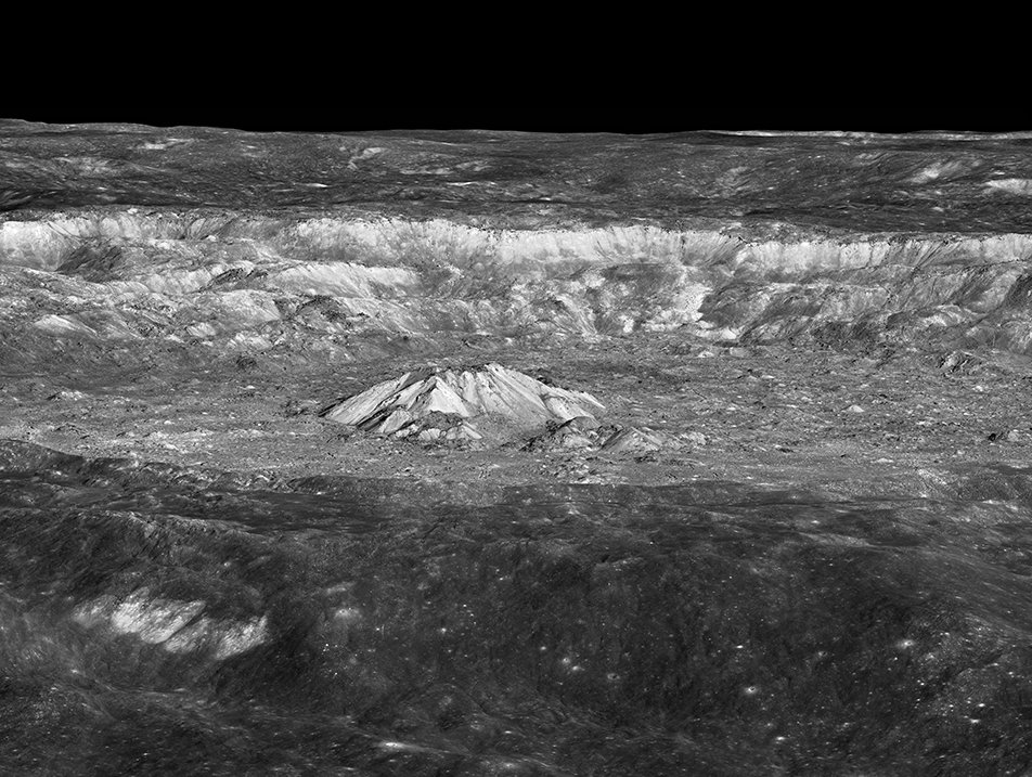 Black and white image of mountains in a crater on the Moon.