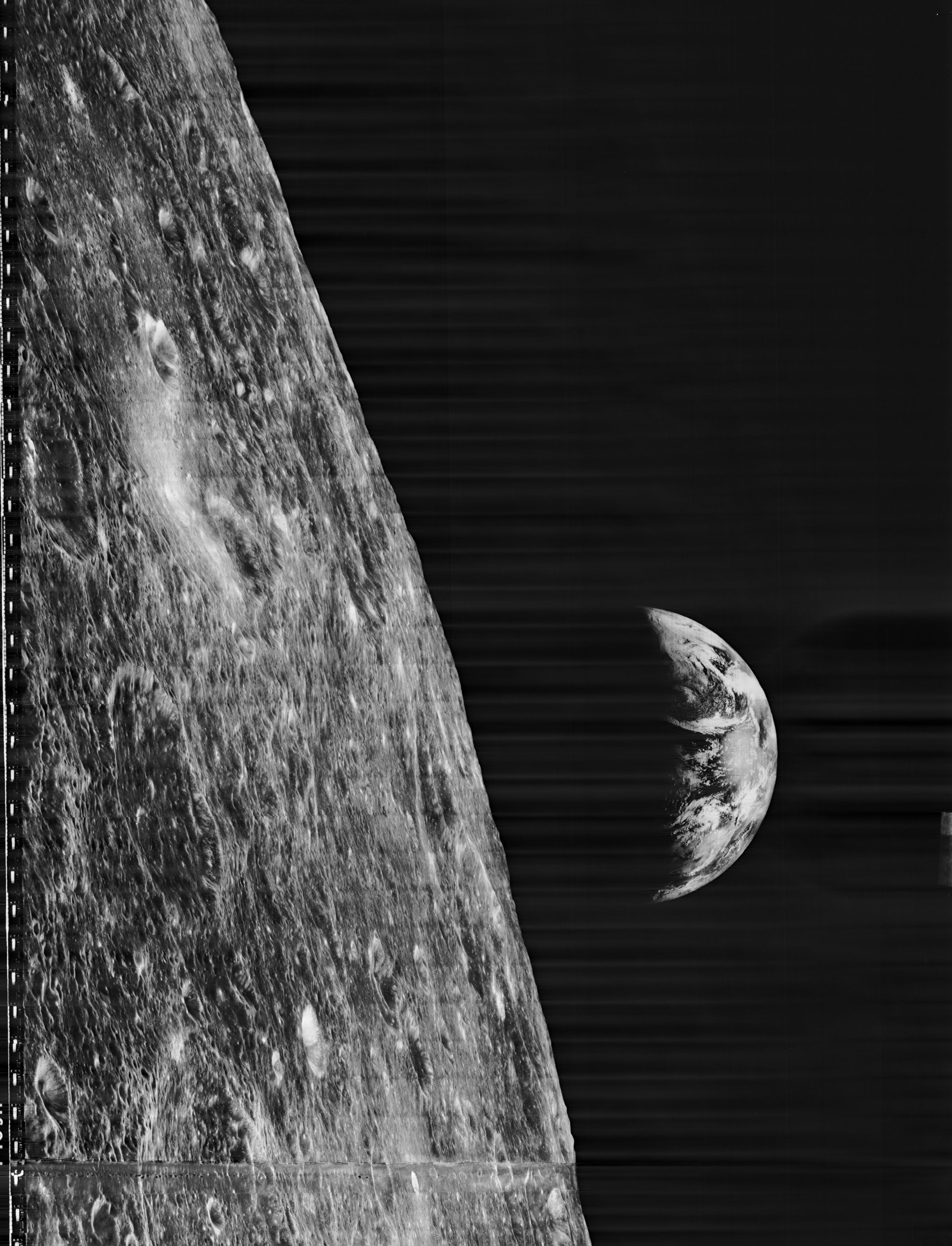 In this image by Lunar Orbiter 1, we view the Moon with the Earth rising to the right.