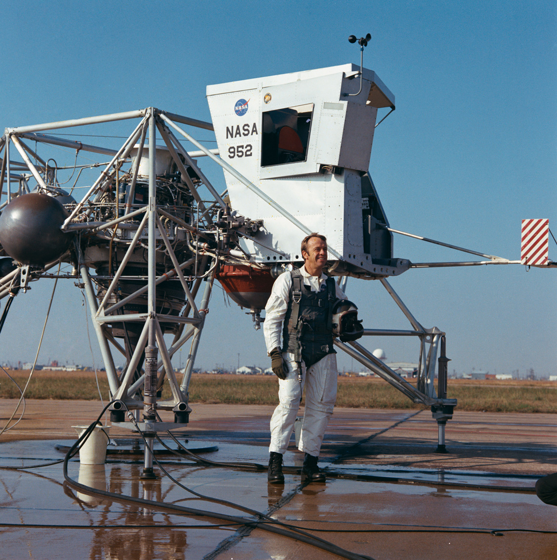 Astronaut standing next to training vehicle