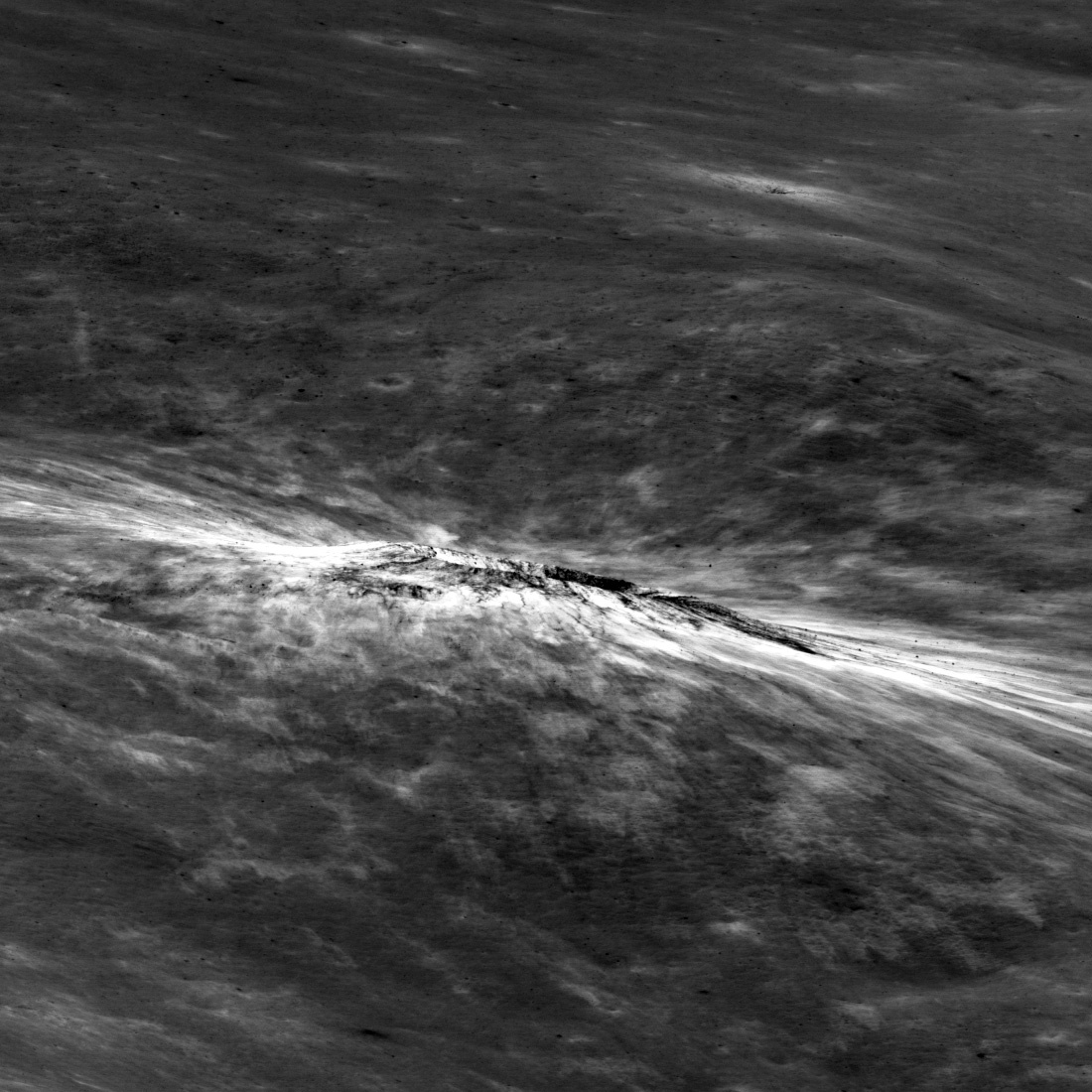 crater seen almost edge on, on a gray plain with bright streaks