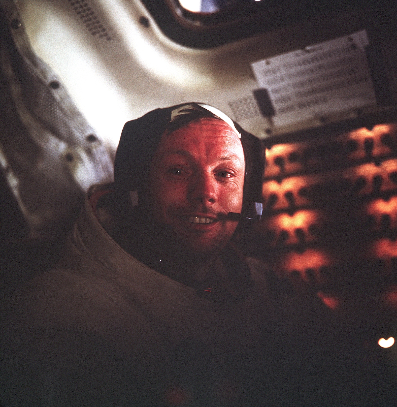 smiling astronaut inside spacecraft