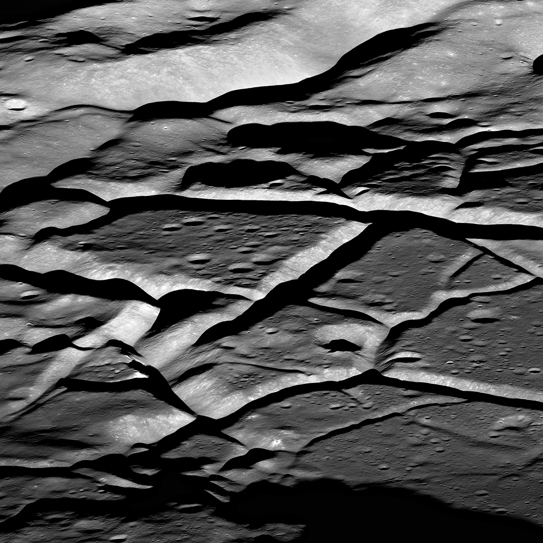 deep grooves in gray lunar terrain