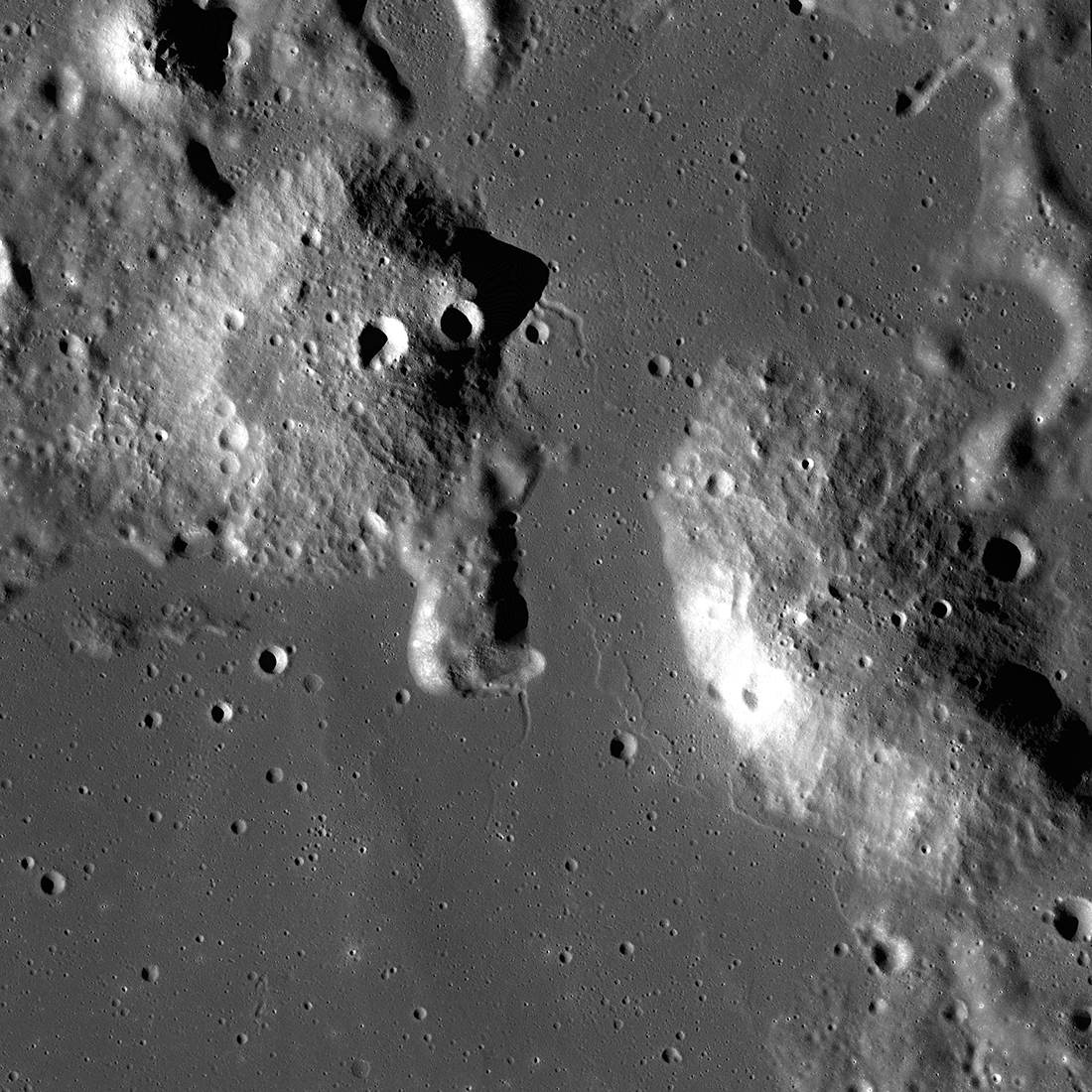 This is an image of the Gruithuisen Domes, taken by the Lunar Reconnaissance Orbiter (LRO). The Gruithuisen Domes protrude outward from the surrounding lunar terrain. The Gruithuisen Domes were formed by eruptions of silicic lavas, which didn't flow outward easily, creating domes.