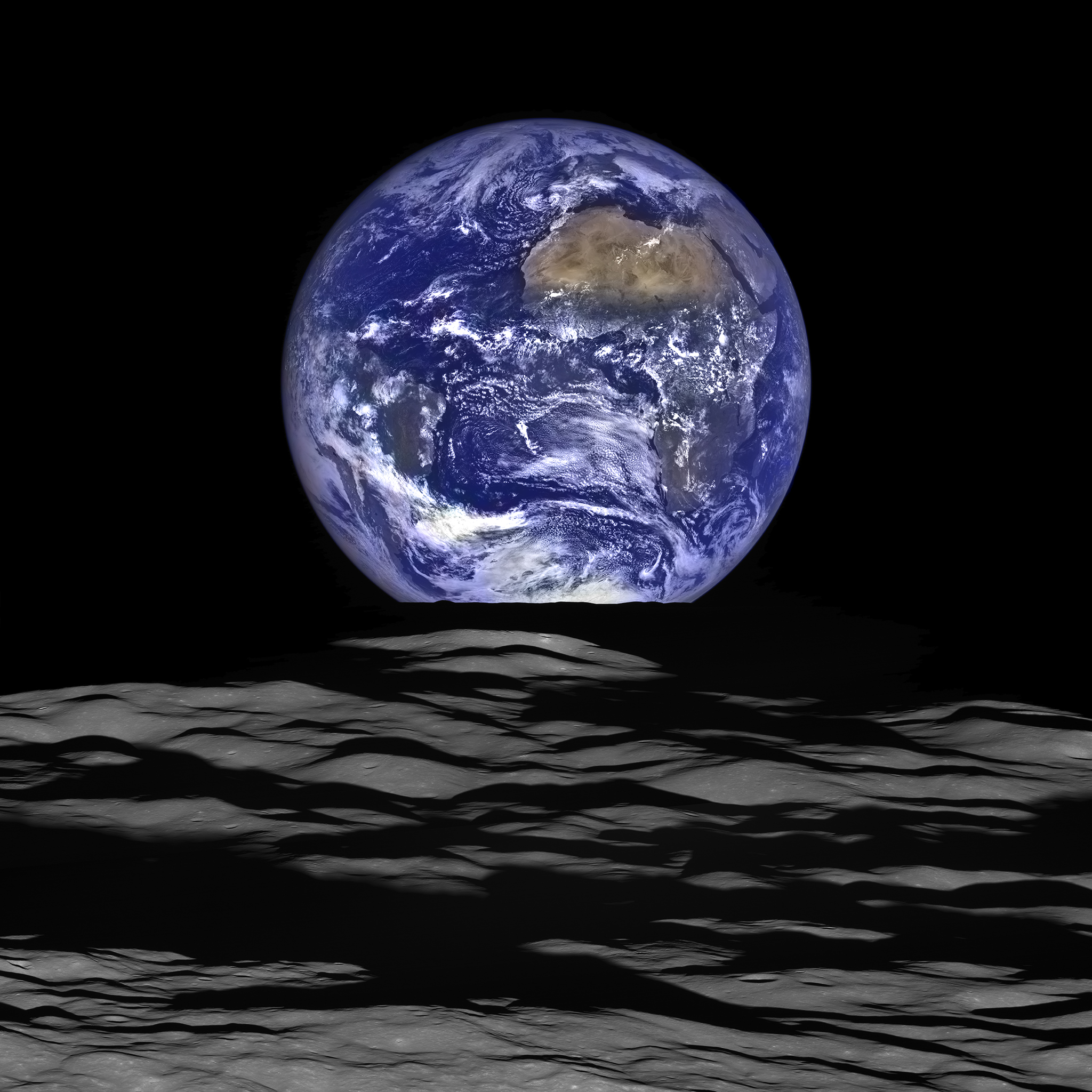 colorful earth rising over barren lunar landscape