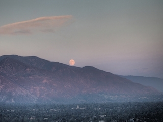 moon rising over mountains